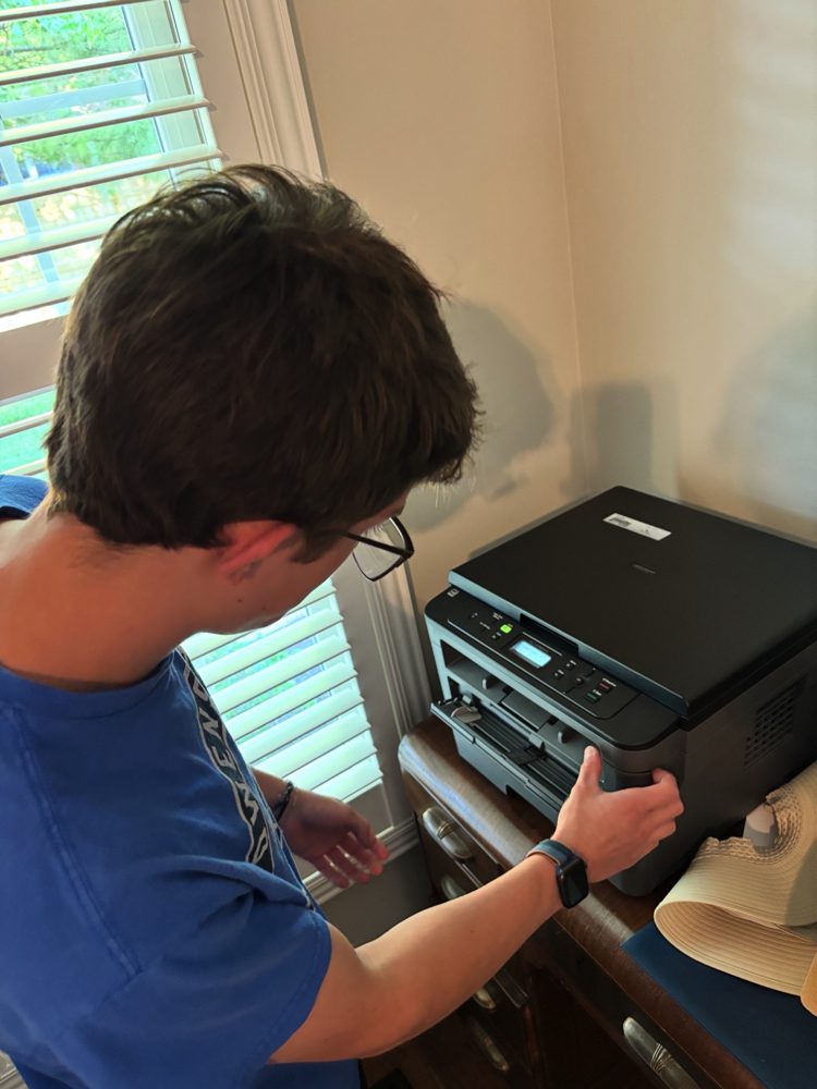 Hands on support with a Brother printer in a home
